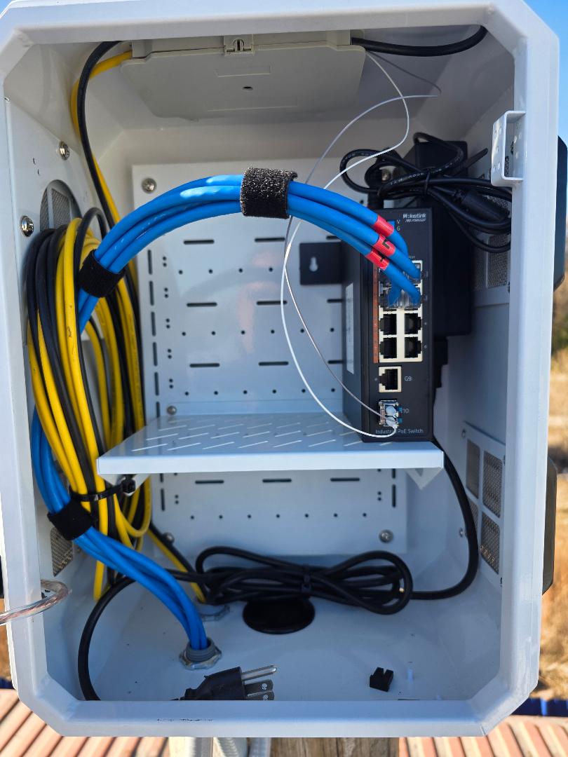 Weatherproof PoE switch enclosure with structured cabling on pole